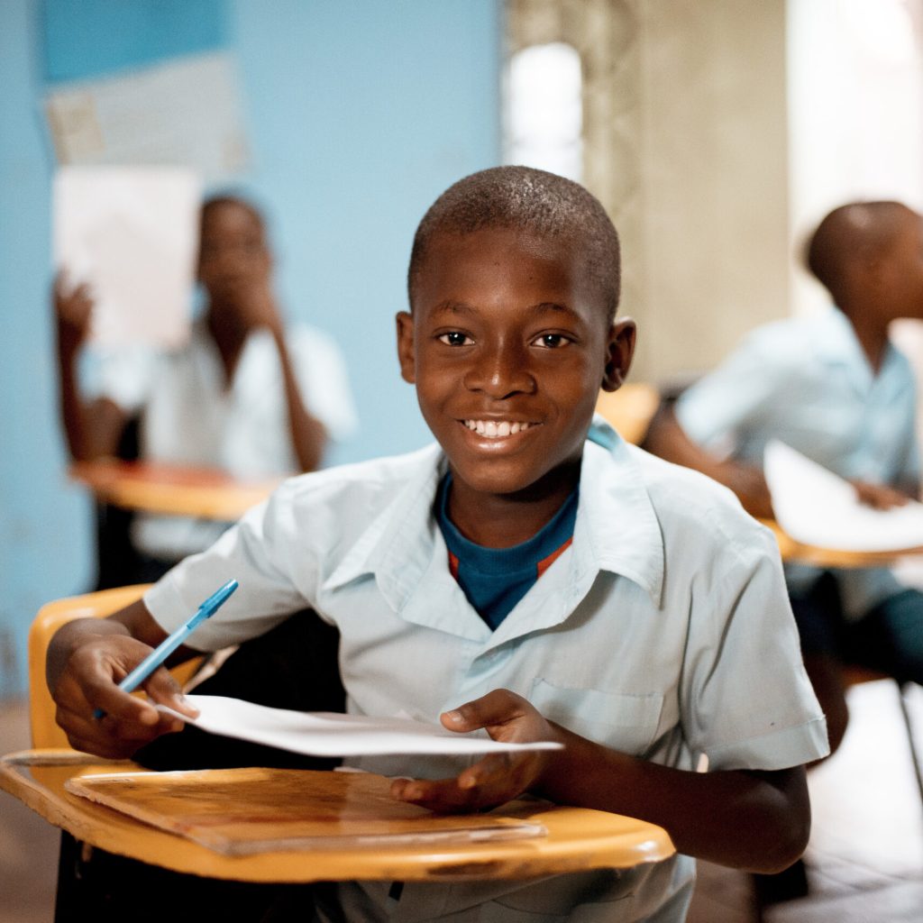 boy holding white paper